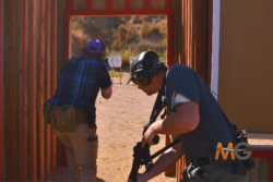 Participants wearing tactical gear out in the field in a rifle firearms training class in Colorado